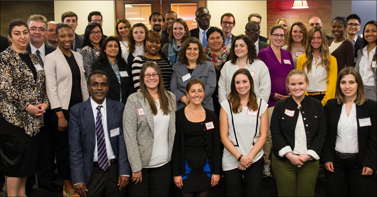 Members of the Upwardly Global Leadership Council standing