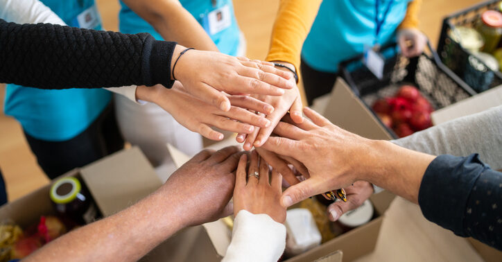 Volunteers hands stacking in a circle